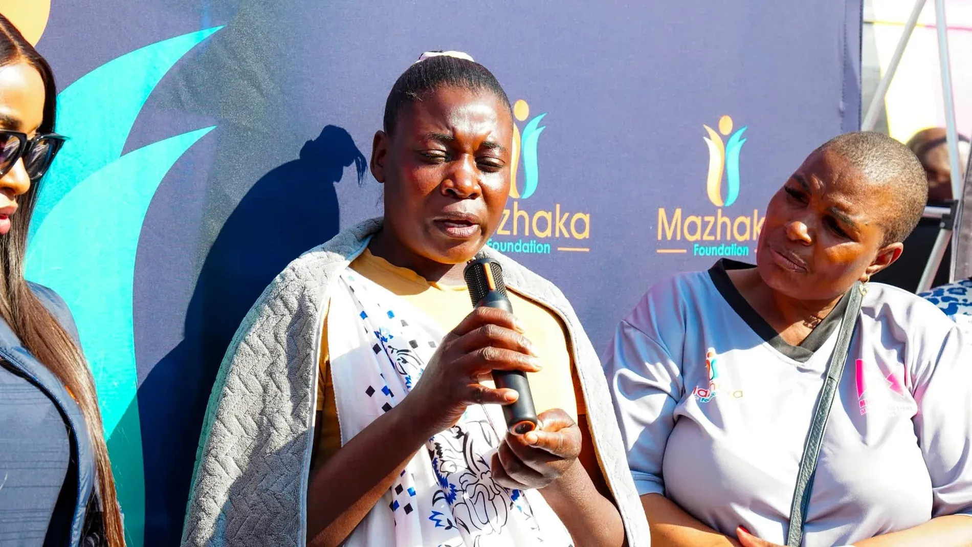 Community speaker with guests at a Mazhaka Foundation event