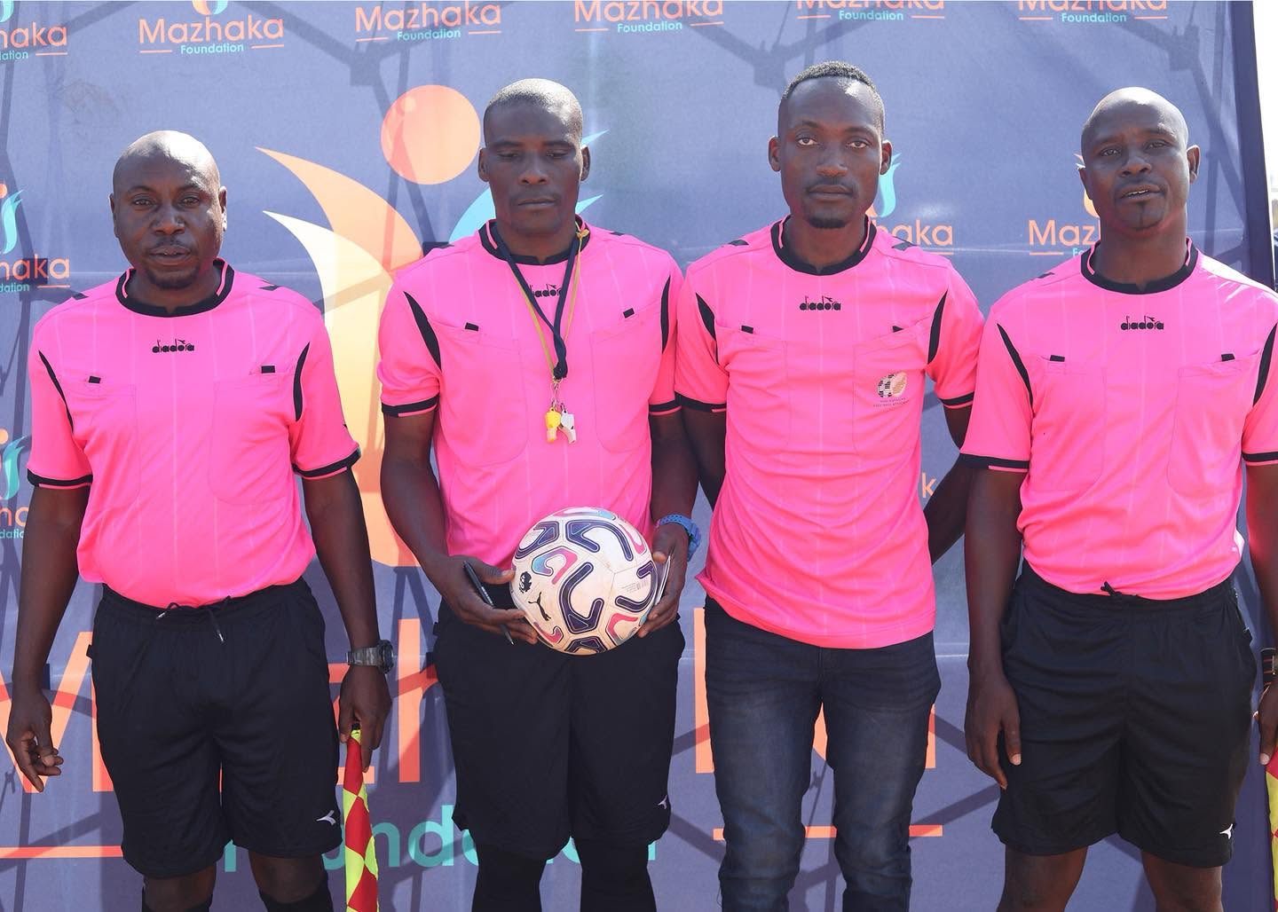 Match officials in pink prepare for the tournament