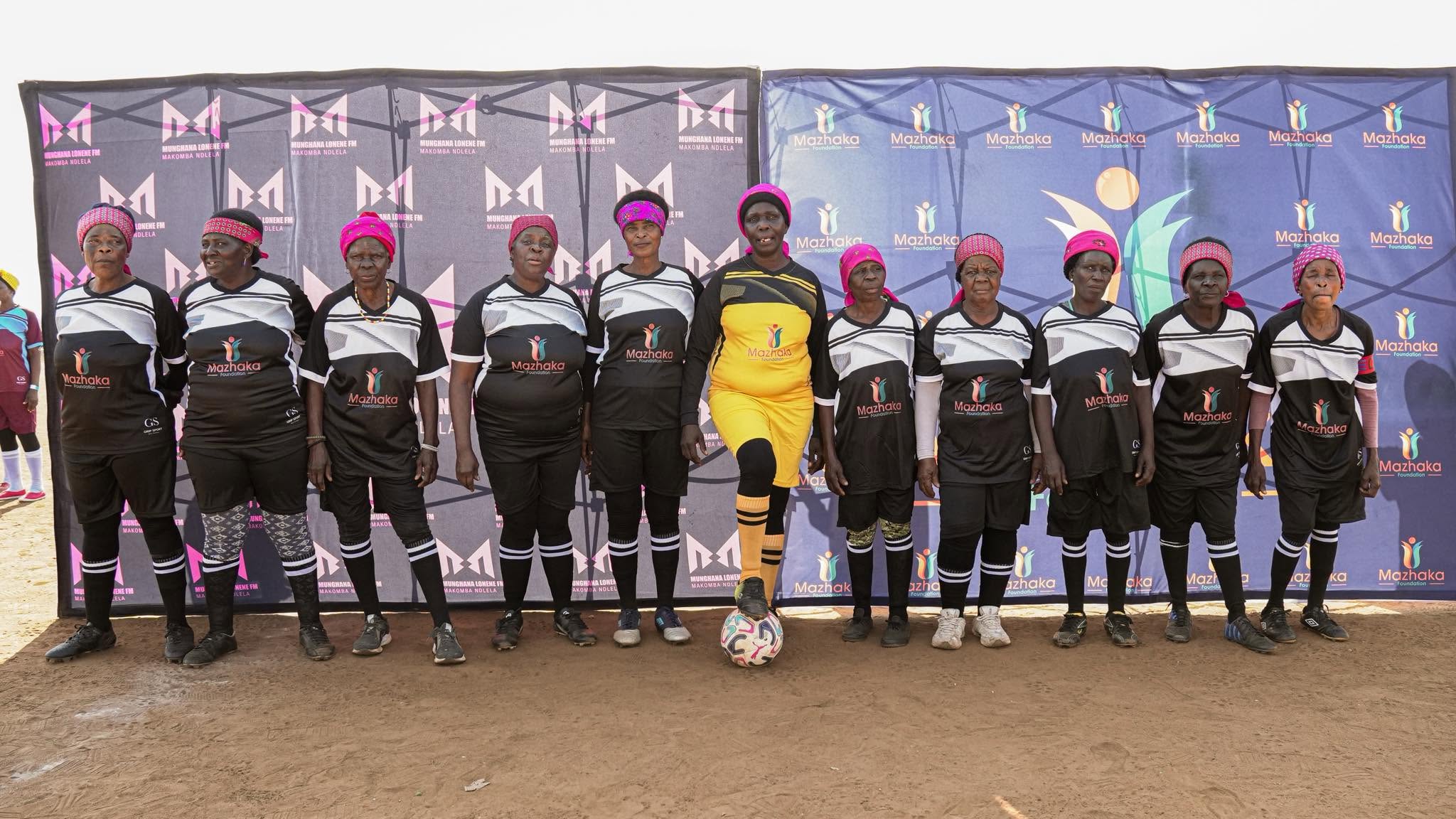 Tournament players pose together on the field
