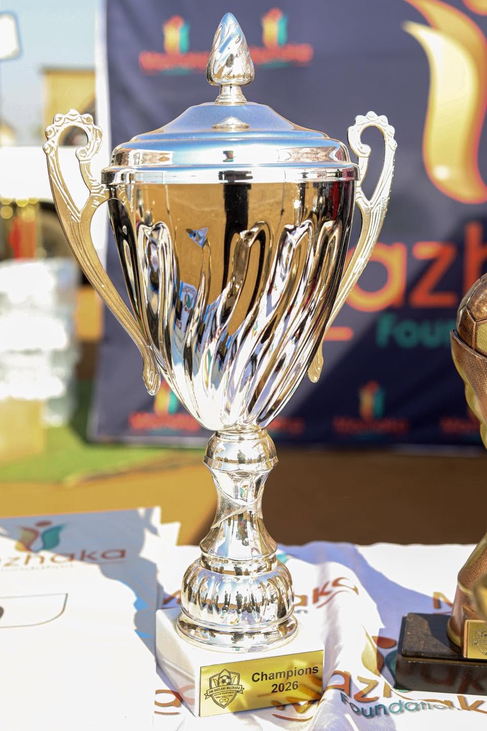 A cup trophy stands on the awards table