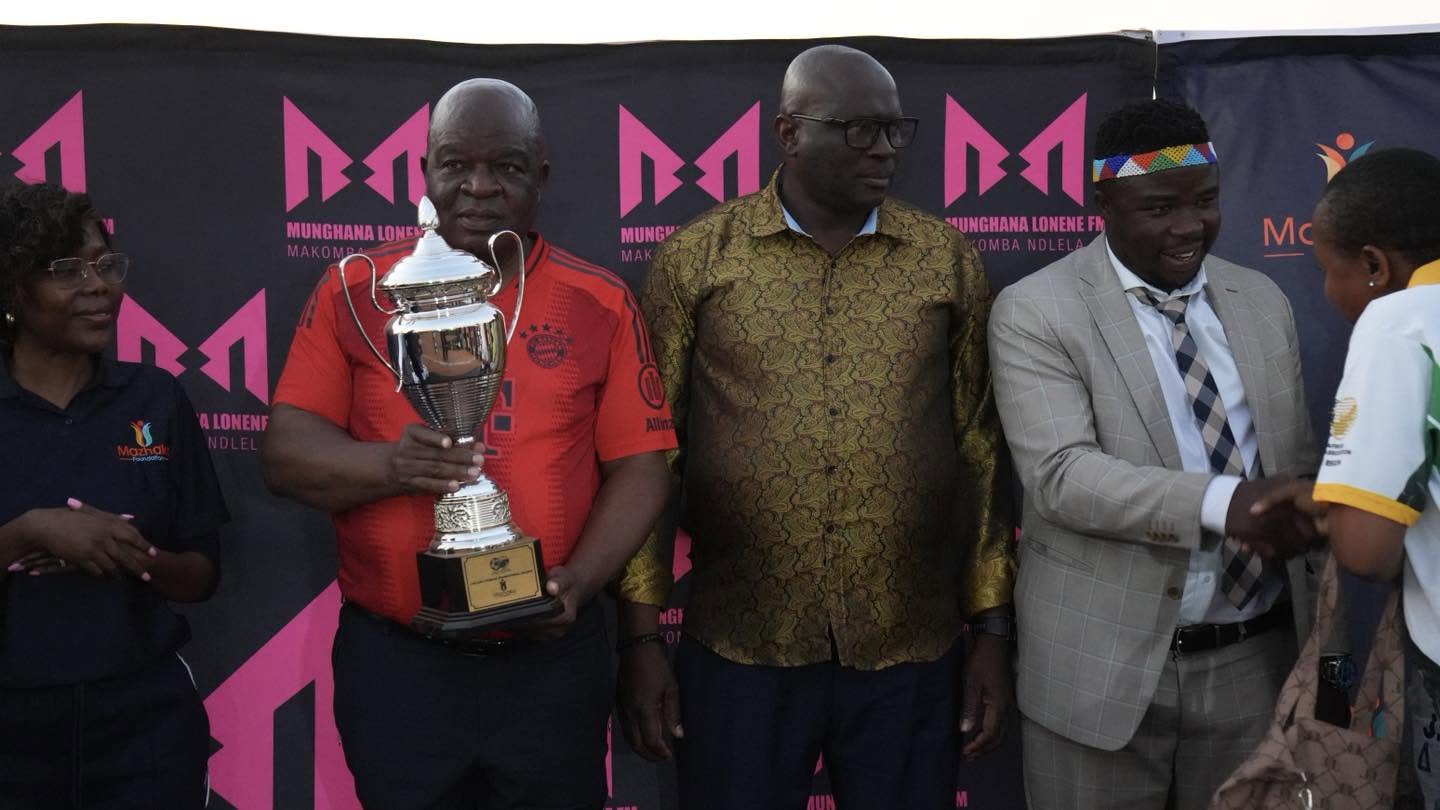 Football players and officials hold their awards