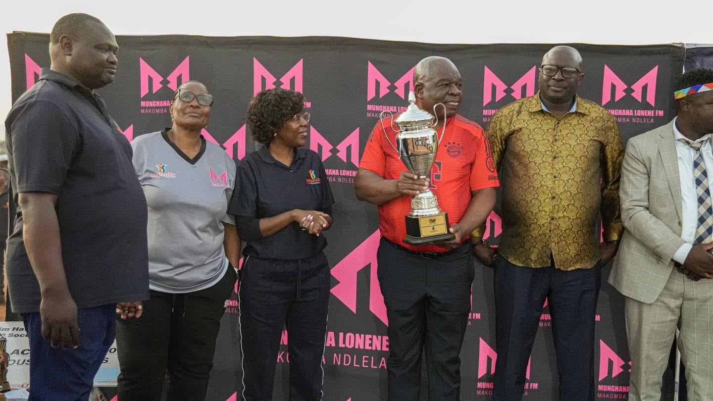 Tournament participants gather around a trophy