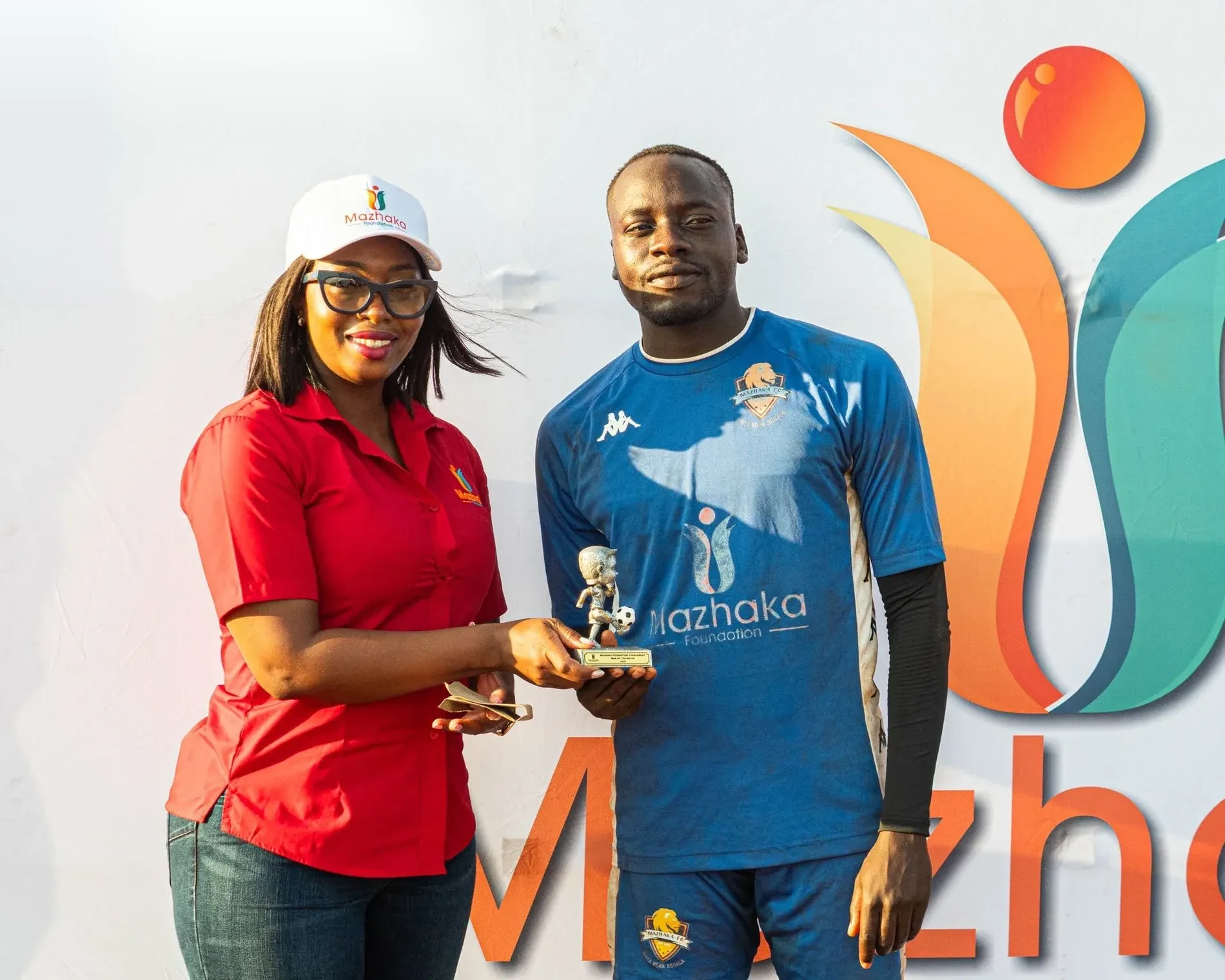A Mazhaka Foundation representative presenting a football award