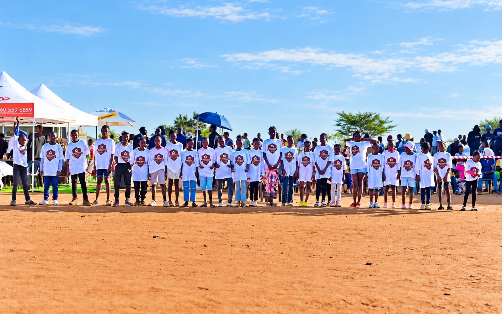 A large group of young people in white shirts together at a community event