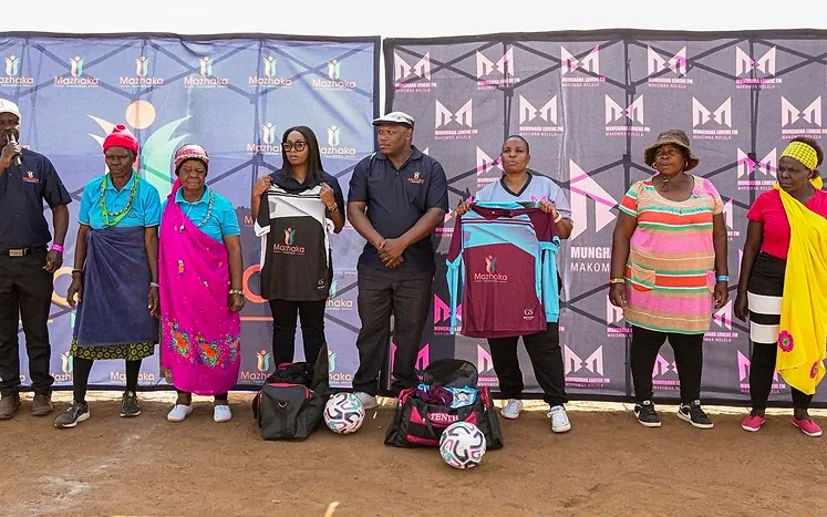 Group holding football kits