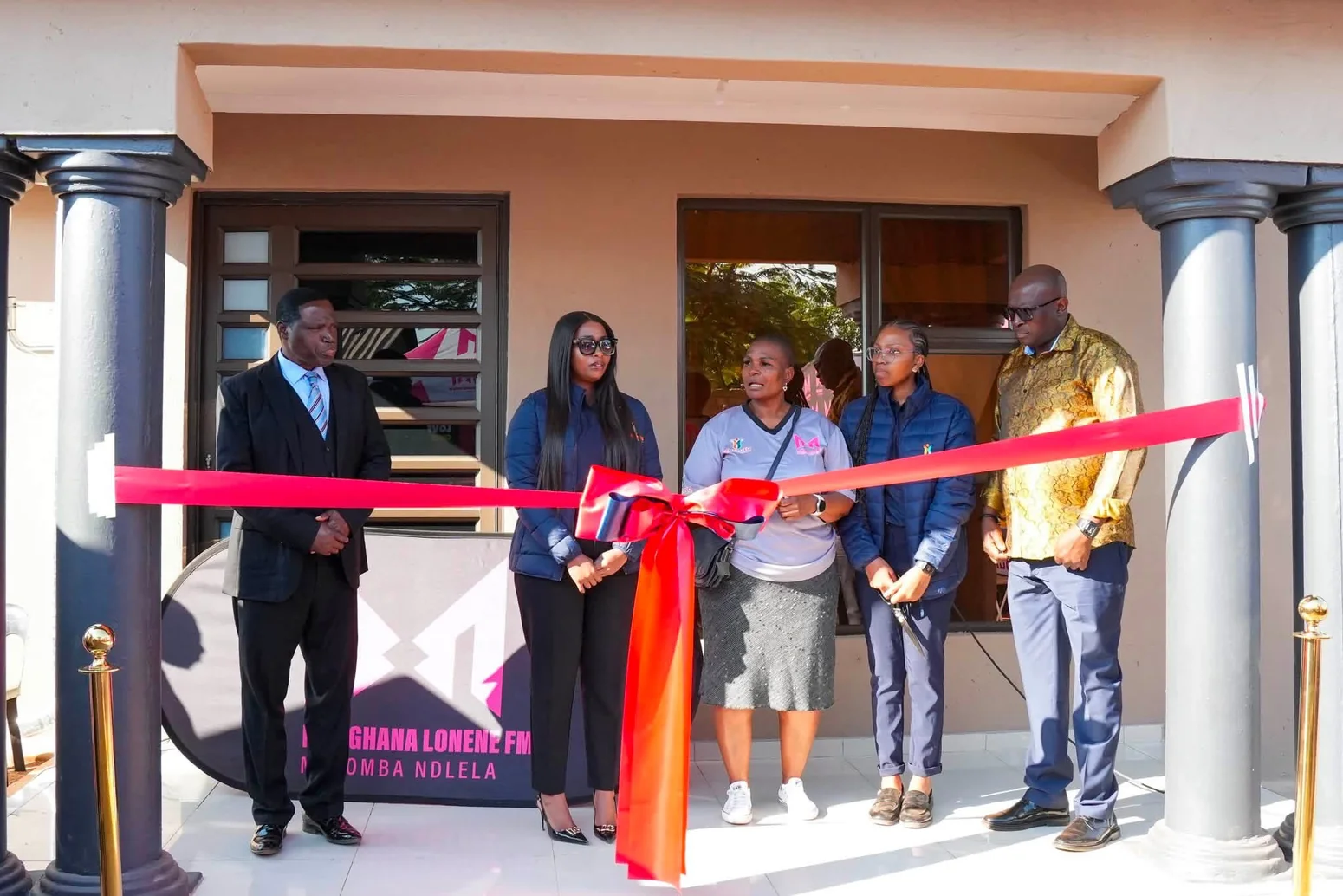 Guests gathering at the ribbon-cutting ceremony outside the donated house